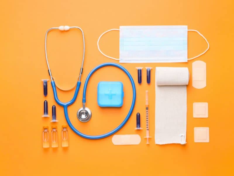 medical supplies needed for your first week as a travel nurse with an orange background