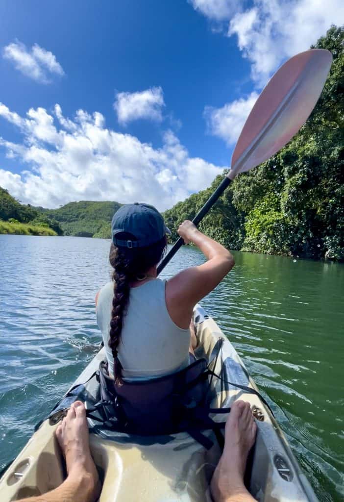 a woman kayaking the Wailua River