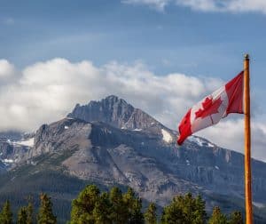 large rocky mountain with canadian flag