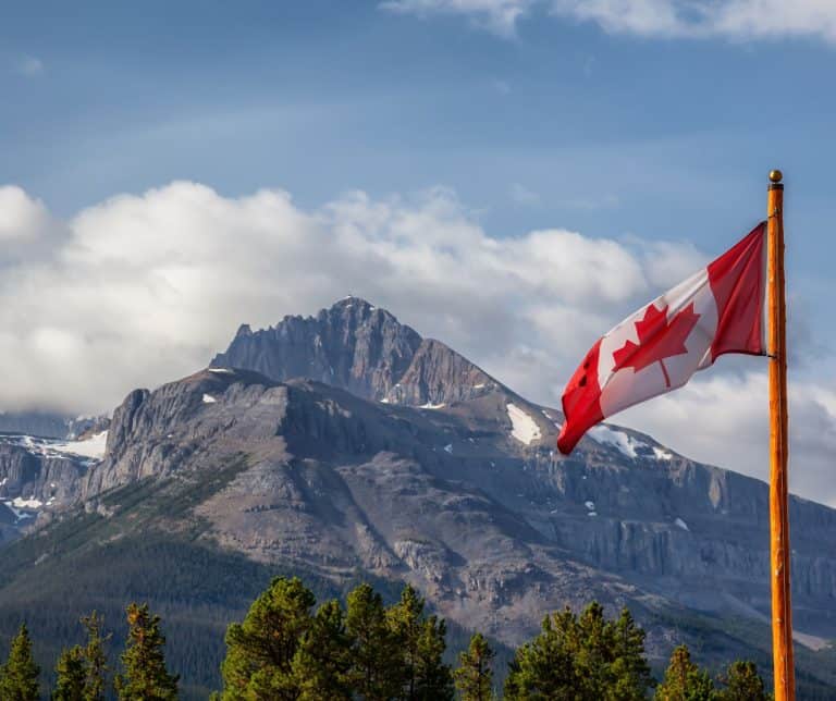 large rocky mountain with canadian flag