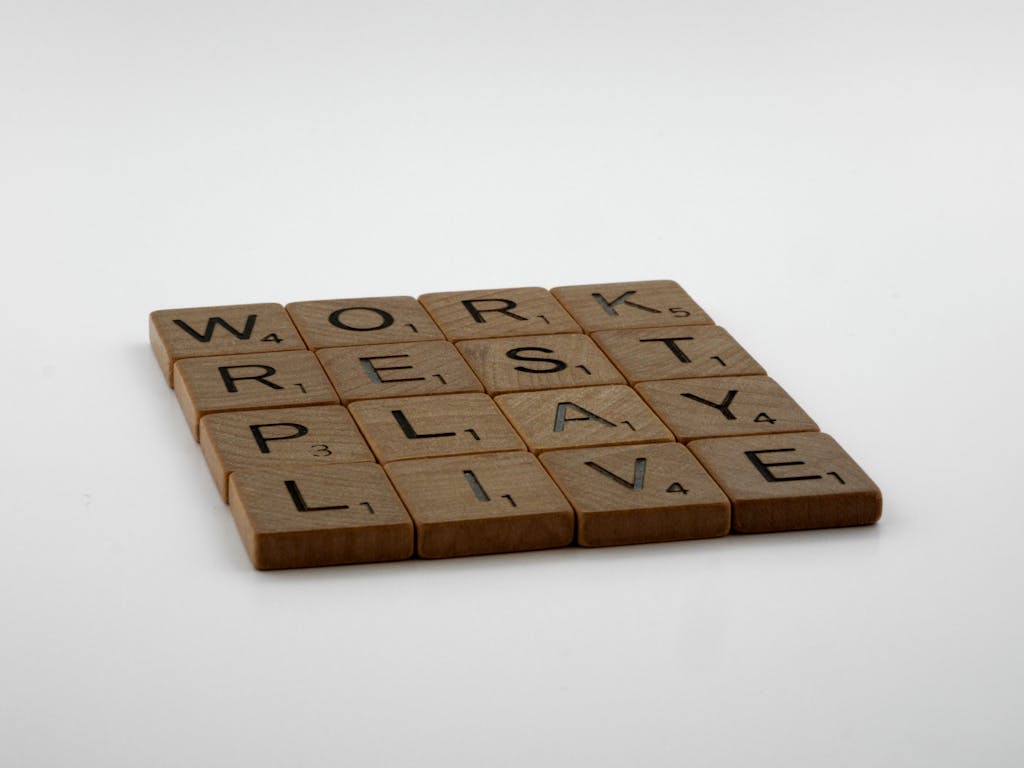 Scrabble tiles spelling work, rest, play, live emphasizing negotiating work life balance as a travel nurse