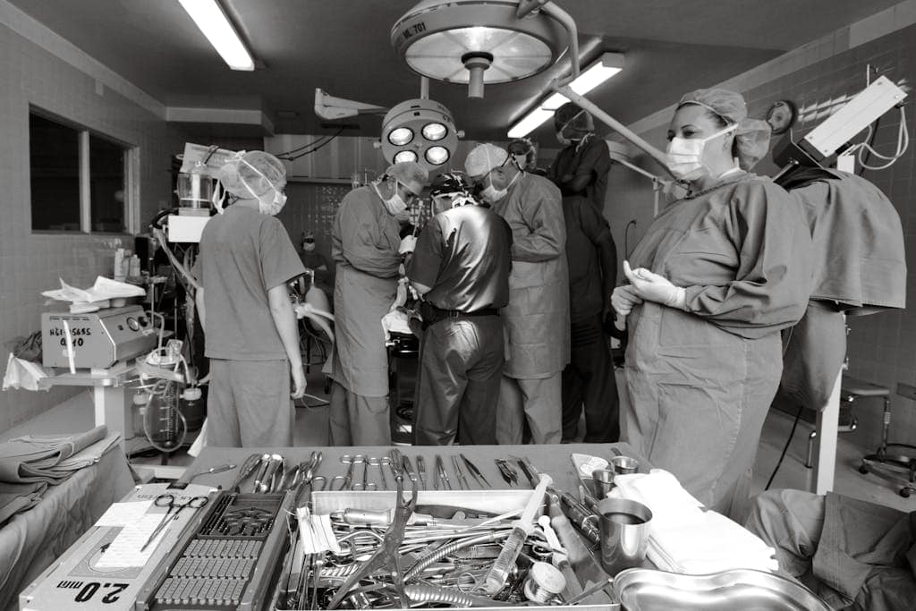 Surgeons and travel nurses working together during a surgical operation in an operating room.