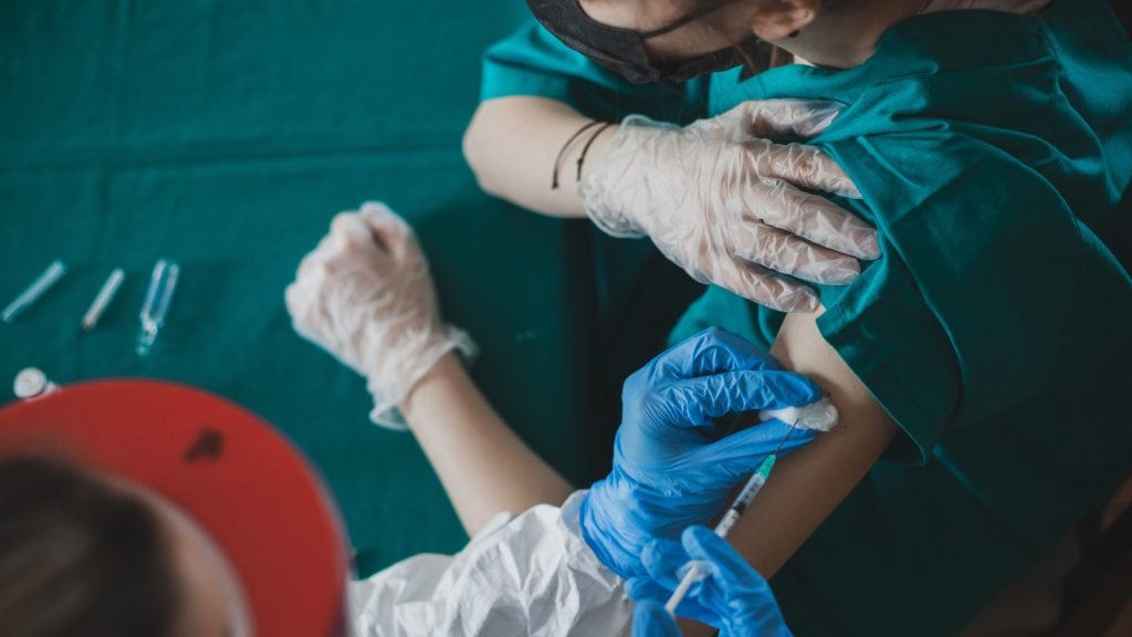 volunteer nurse giving an immunization